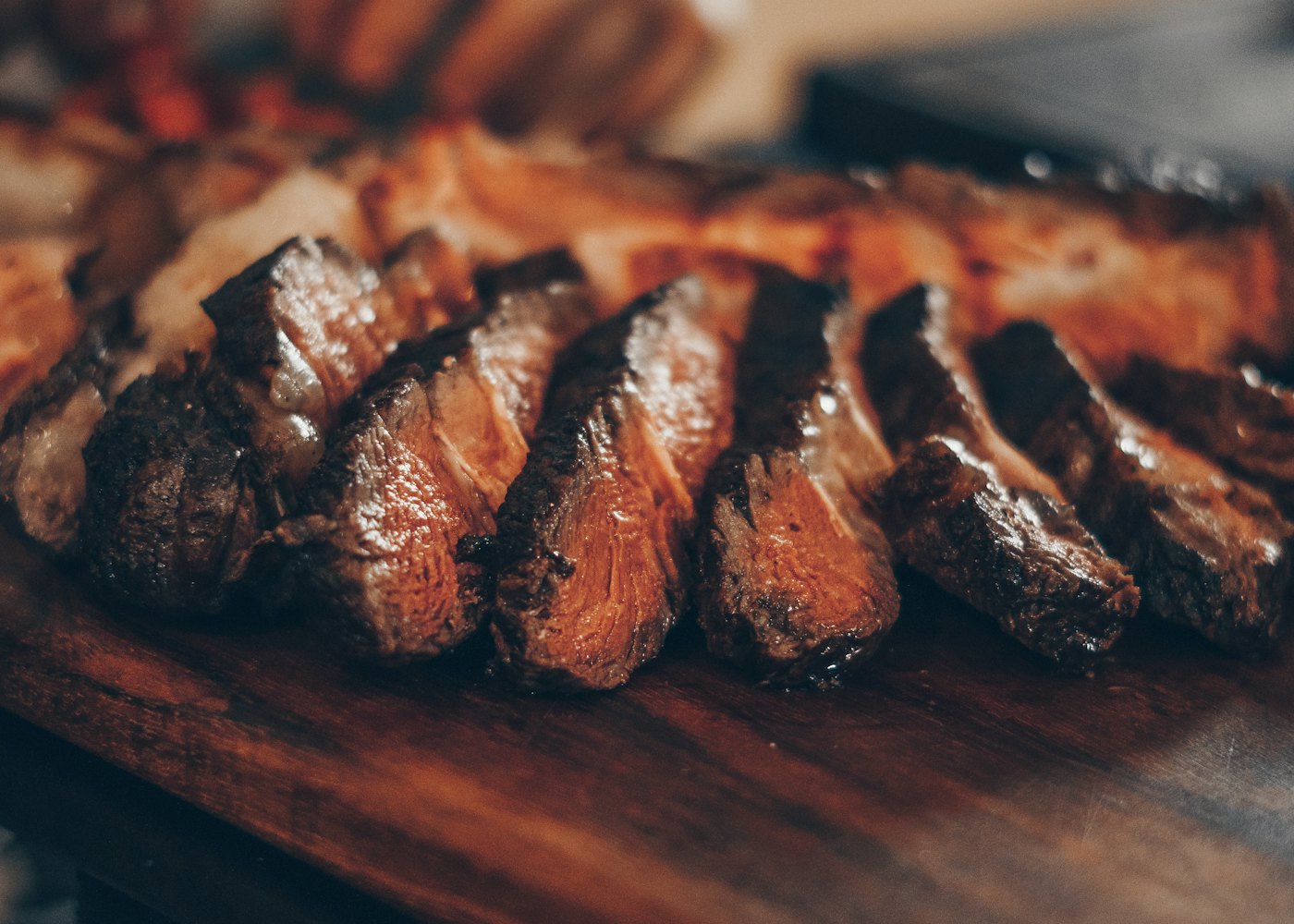 Carne madurada cortada en lonchas sobre una tabla de madera